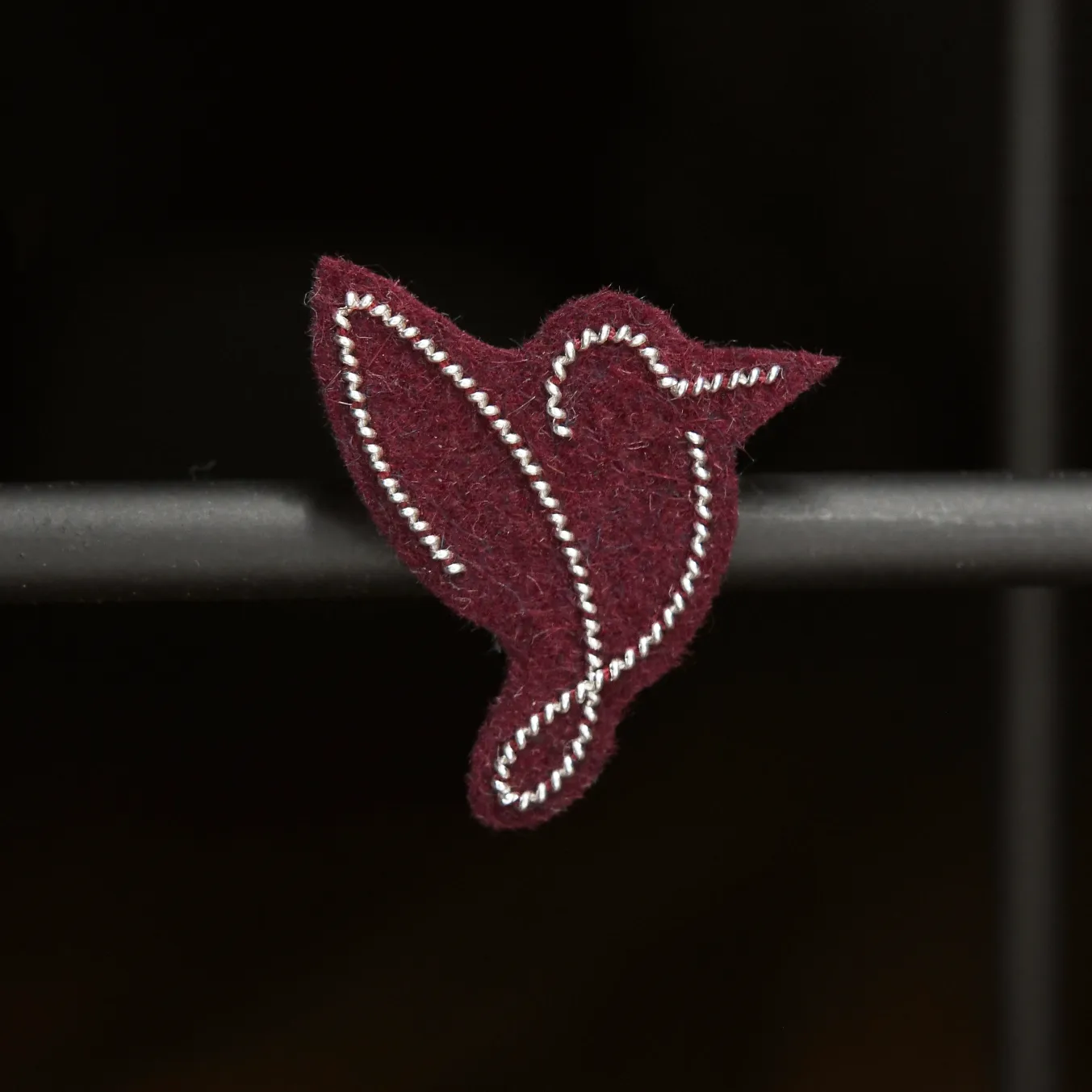 Pin's oiseau (argent, fond bordeaux)
